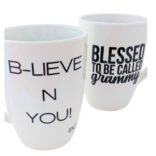 Two white mugs with motivational phrases on a white background